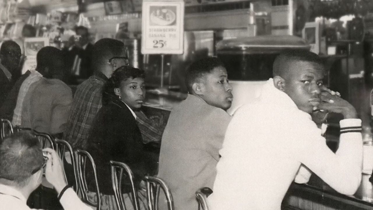 An old photo of students sitting at a lunch counter
