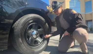 Trooper Migdalisis Garcia, Florida Highway Patrol, checking the air pressure on her vehicle. (Spectrum News/Kiara Velez)