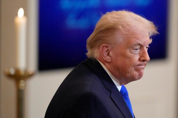 President Donald Trump leaves after an event in the East Room of the White House.