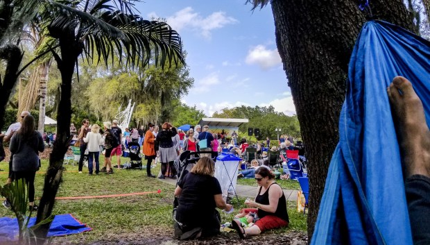 A view from a hammock shows Indie-Folkfest in the Mennello Museum of American Art Sculpture Garden. (Patrick Connolly/Orlando Sentinel)