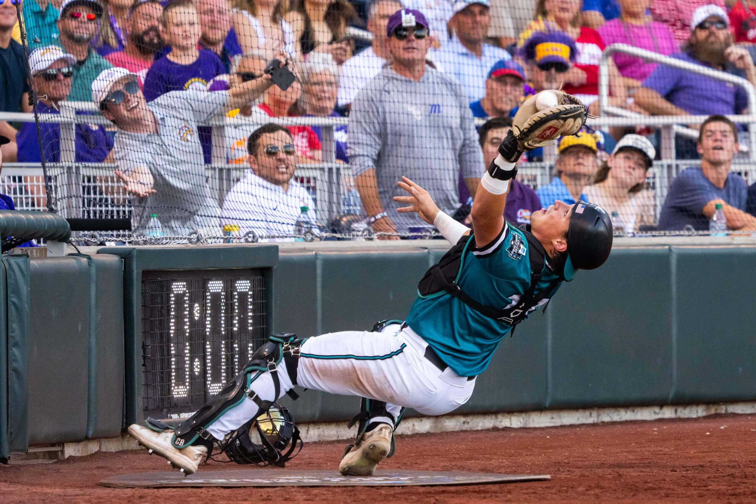 Coastal Carolina Chanticleers catcher Caden Bodine (17) catches for an out against the LSU Tigers during the third inning at Charles Schwab Field. 