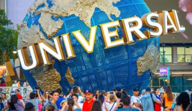 guests gather around spinning globe at Universal Orlando Resort. Volcano Bay Nights Universal Orlando