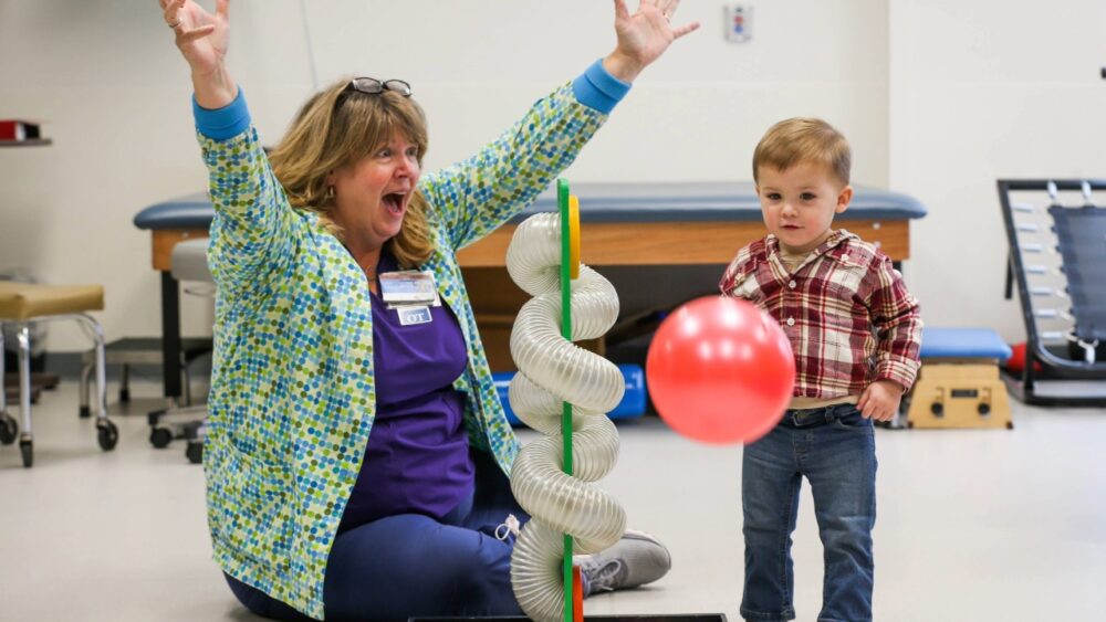 Occupational therapist Katrina Kenny works with a young patient during a therapy session at Shriners Children’s.