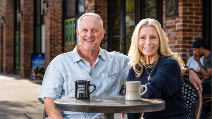 Susan and Dave Ward sit at an outdoor table with coffee outside the Buddy Brew Coffee location in Hyde Park.