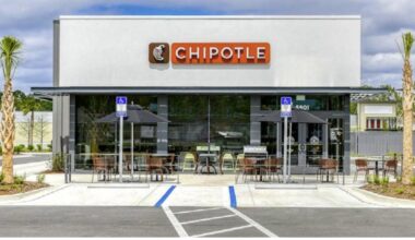 Exterior of a Chipotle Mexican Grill restaurant with patio seating in Lutz, Florida.