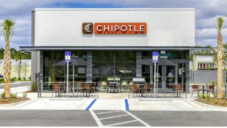 Exterior of a Chipotle Mexican Grill restaurant with patio seating in Lutz, Florida.
