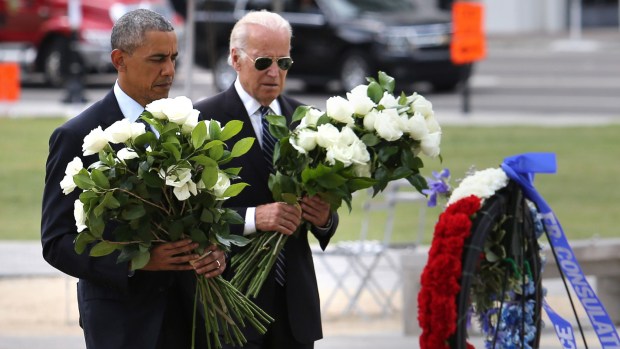President Barack Obama and Vice President Joe Biden place flowers during their visit to the makeshift memorial at the Dr. Phillips Center for the Performing Arts, honoring those killed in the Pulse club massacre, in downtown Orlando, Fla., Thursday, June 16, 2016. (Joe Burbank/Orlando Sentinel