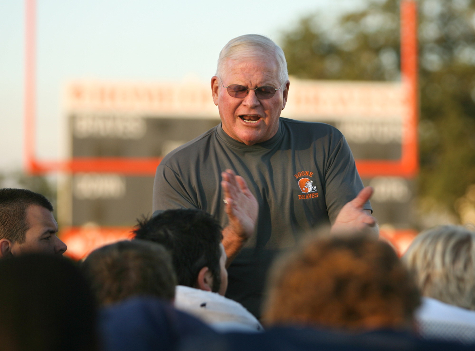 Boone High School head coach Phil Ziglar talks to players...