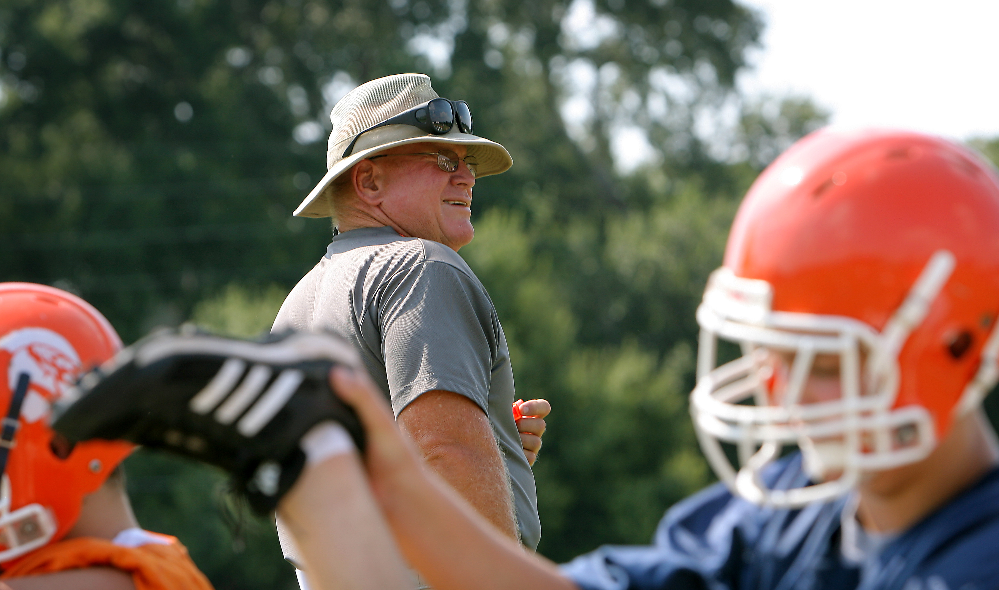 Boone head football coach Phil Ziglar watches his team stretch...
