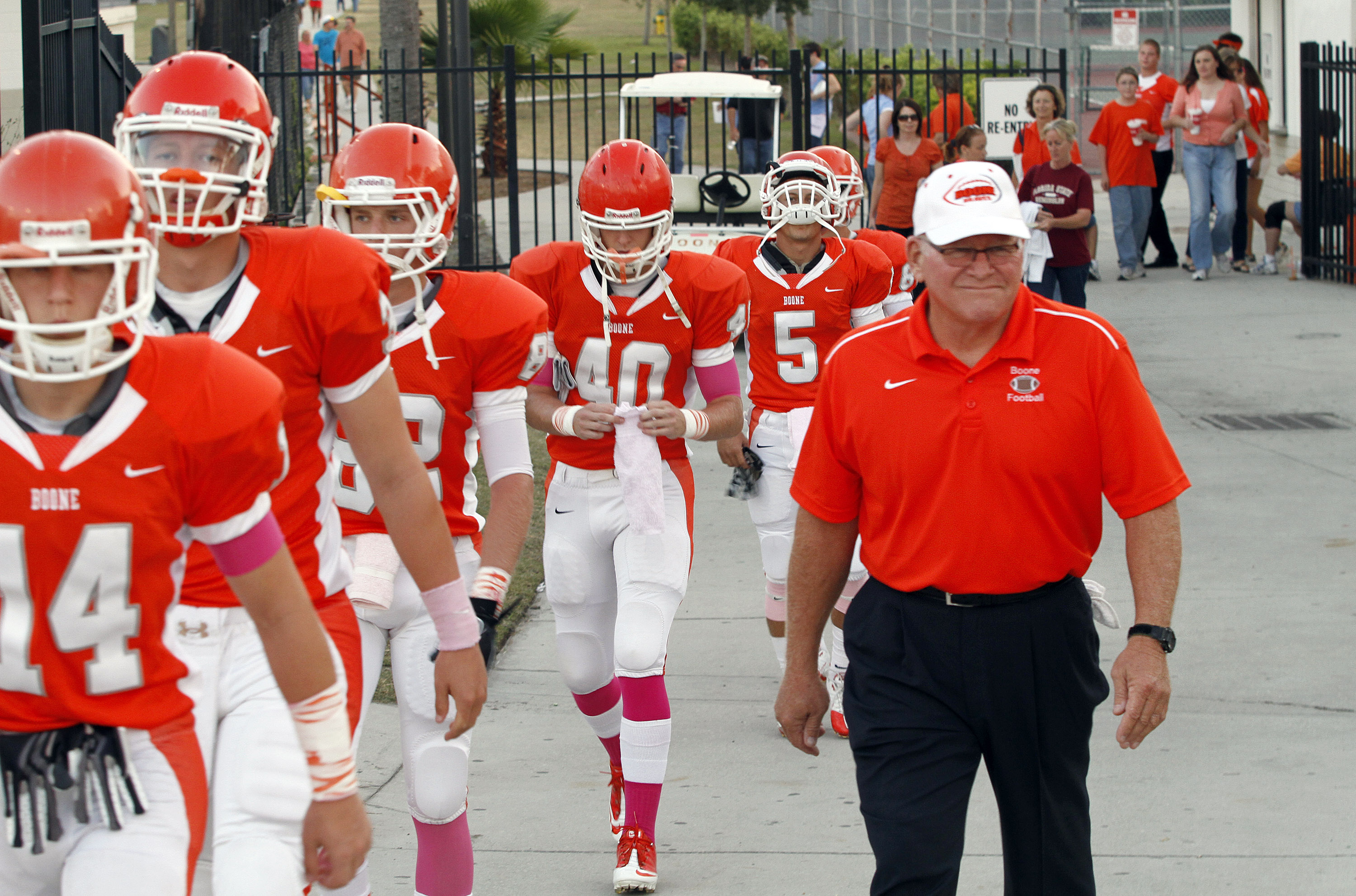 Coach Phil Ziglar walks his team onto the field before...