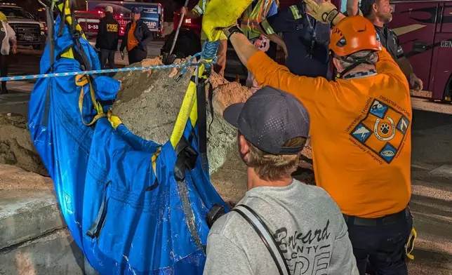 This photo provided by Brevard County Fire Rescue shows members of Brevard County Fire Rescue help rescue a manatee that was stuck in a storm drain on Monday, Feb. 9, 2026 in Melbourne Beach, Fla. (Brevard County Fire Rescue via AP)