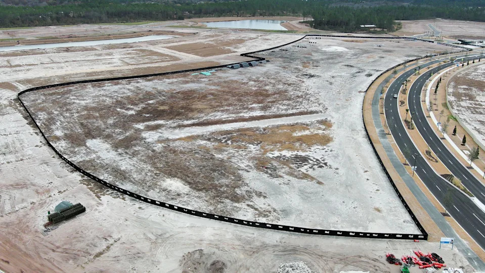 A fence surrounds the area where the lagoon will be built at Diamond Springs, Wednesday morning, February 11, 2026 in Jacksonville, Fla. Metro Development Group is developing the land near Cecil Airport. The lagoon concept is designed for kayaking and swimming, with amenities such as a swim-up bar, a floating obstacle course and a splash pad. [Doug Engle/Florida Times-Union]