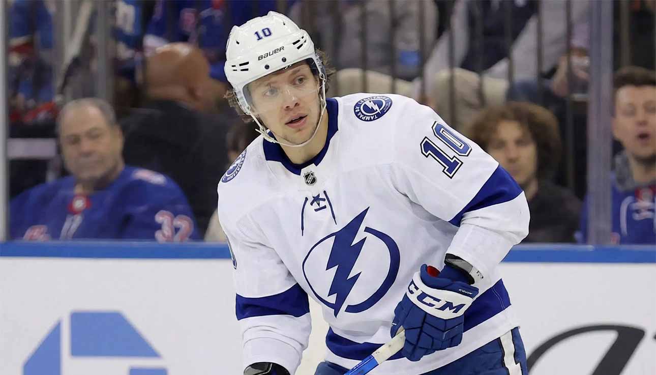 A concept illustration showing current New York Rangers forward Artemi Panarin wearing a white Tampa Bay Lightning away jersey with the number 10, blue pants, and blue gloves, standing on the ice and looking towards the left.