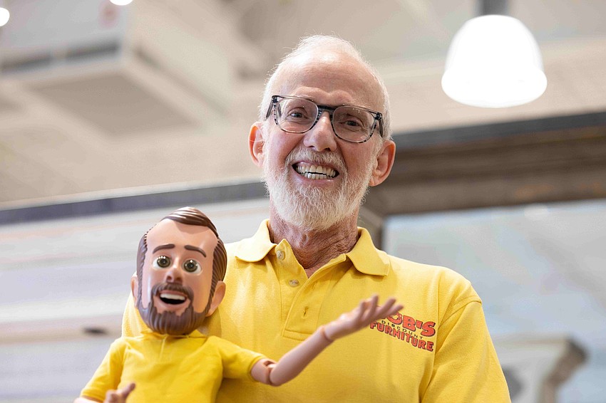 Bob Kaufman, the founder of Bob’s Discount Furniture, and the puppet called “Little Bob” that appears in ads for the chain.