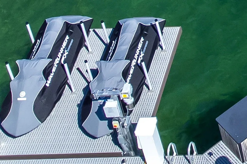 Two Yamaha WaveRunners sit mounted on lifts over the water, each valued at roughly $20,000. New York Post