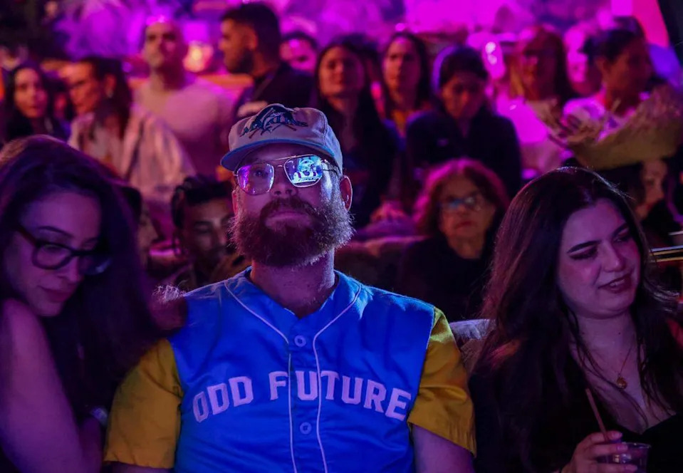 Kenny O’Brien, of South Miami, is focused on the show as the telecast is displayed on one lens of his glasses. 