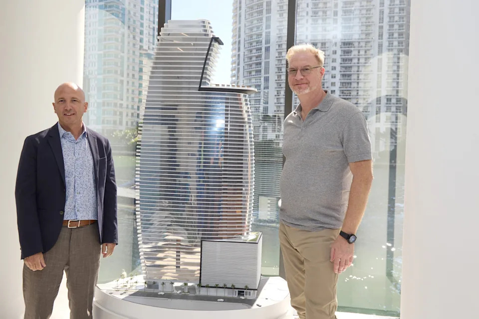 German Coto and Marek Reichman with a model of the Aston Martin Residences in Biscayne Miami
