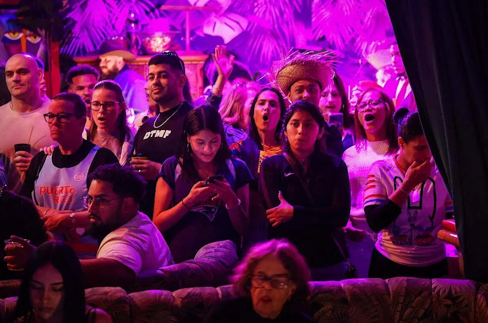 Bad Bunny fans watch the Super Bowl as they wait for his halftime show. 