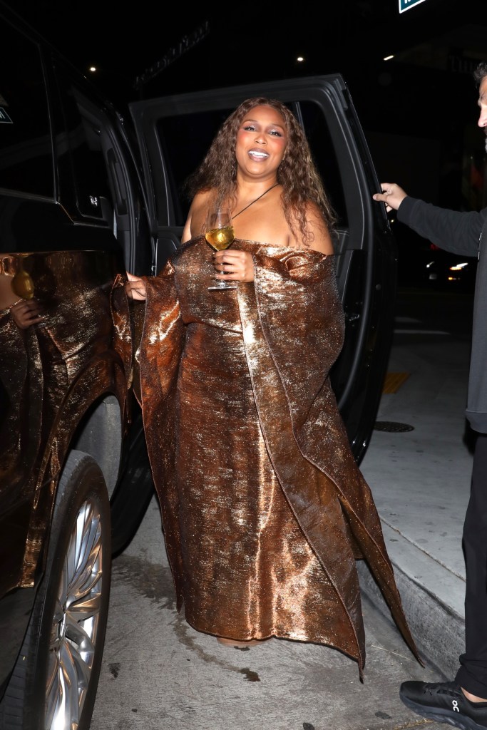 Lizzo grabs some wine to go while exiting the final night of a three-night stint at the Blue Note Jazz Club in Hollywood, Calif. 