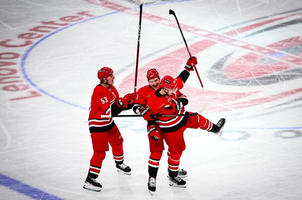 Right wing Jackson Blake (left) and defenseman Dimitri Orlov (middle) celebrate with center Sebastian Aho after a goal during the game against the Columbus Blue Jackets in the Lenovo Center on Thursday, Jan. 23, 2025. The Hurricanes scored five goals in the second period. Carolina defeated Columbus 7-4.