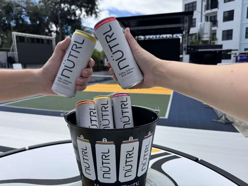 People holding drinks at a bar