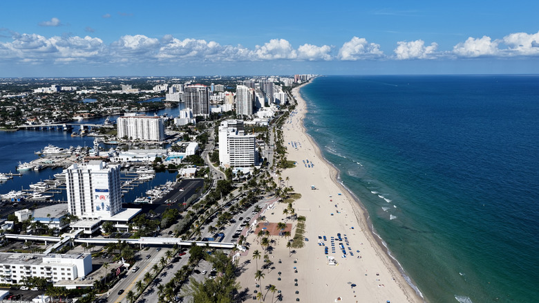 Aerial view of Fort Lauderdale with the white beach, ocean, high-rise apartments, canals, and yachts