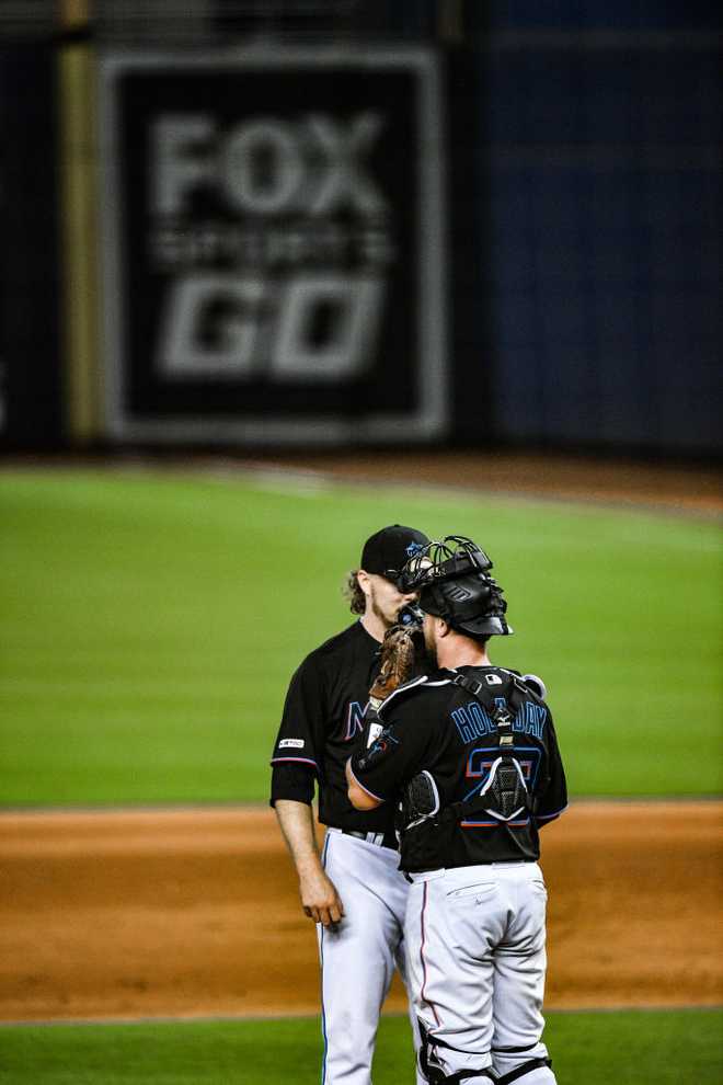 MIAMI, FL - AUGUST 10: Ryne Stanek #35 speaks with Bryan Holaday #28 of the Miami Marlins on the mound during the game against the Atlanta Braves at Marlins Park on August 10, 2019 in Miami, Florida. (Photo by Mark Brown/Getty Images)