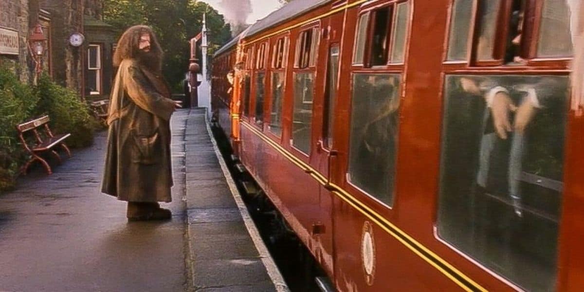 Hagrid sends the Hogwarts Express off, saying goodbye to Harry Potter, Hermione Granger, and Ron Weasley in 'Harry Potter and the Philosopher's Stone'