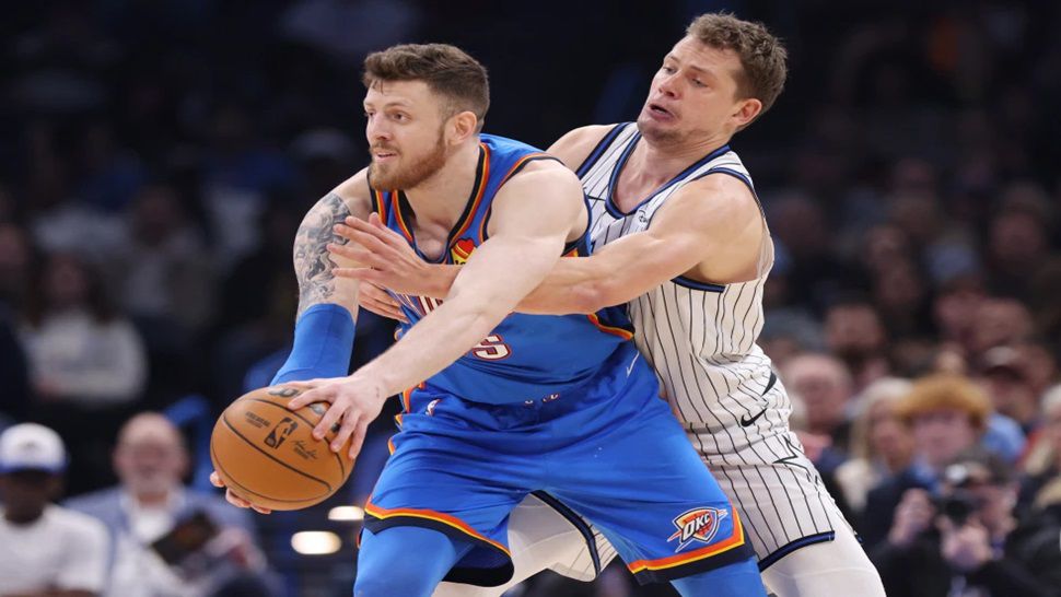 Oklahoma City Thunder center Isaiah Hartenstein, front, keeps the ball away from Orlando Magic forward Moritz Wagner, back, during the first half of an NBA basketball game, Tuesday, Feb. 3, 2026, in Oklahoma City. (AP Photo/Nate Billings)