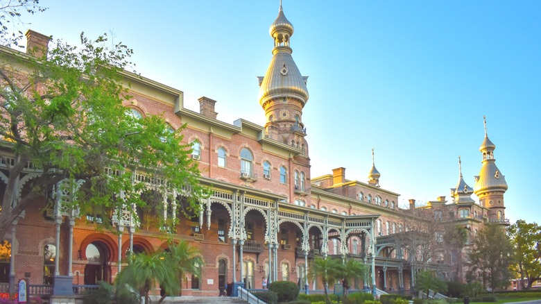 brick museum building with turrets and greenery
