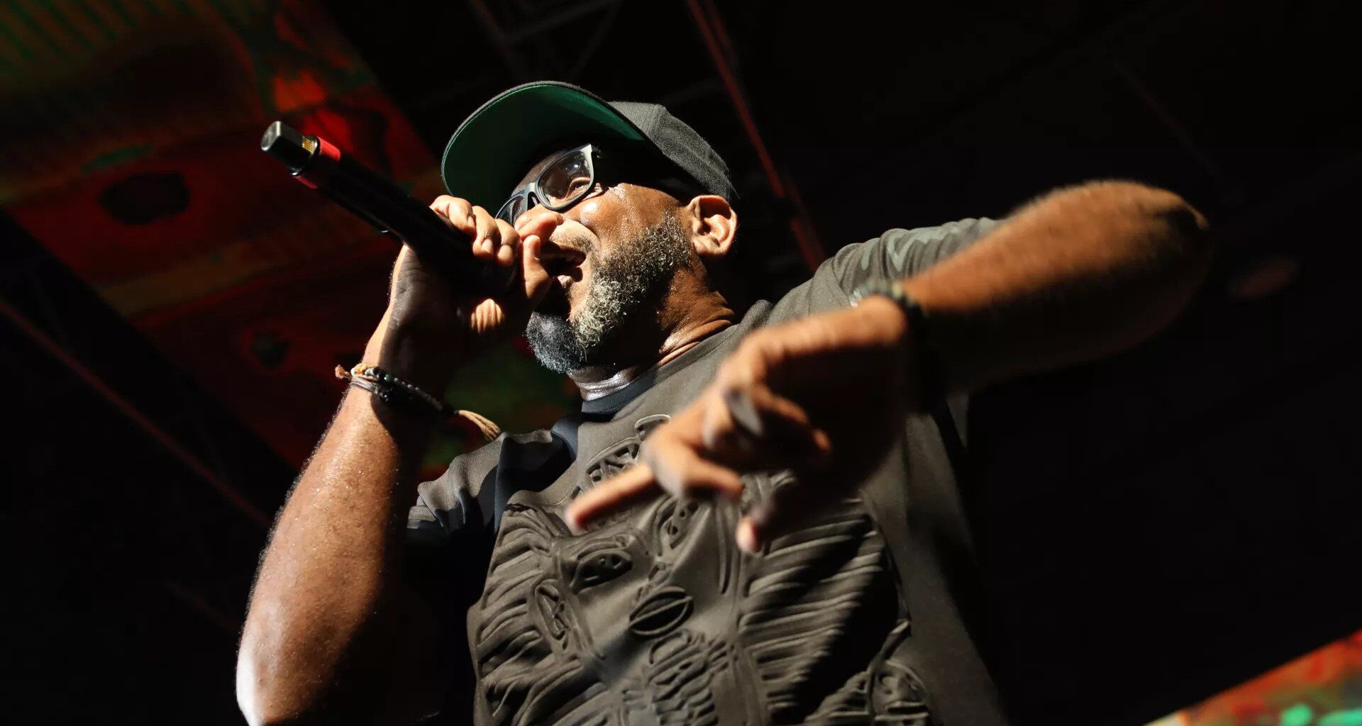 Photo pf a man holding a mic on stage.