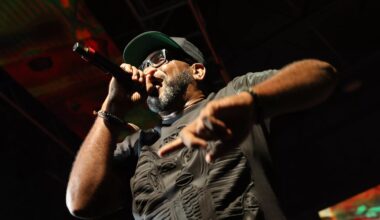 Photo pf a man holding a mic on stage.