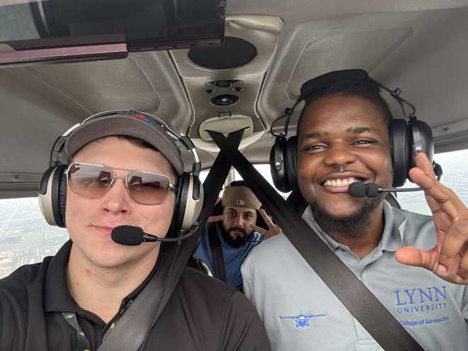 Flight instructor Bob Steffy, pilot Maurice Mark, and Joseph Albergo aboard an aircraft, Dec. 2025