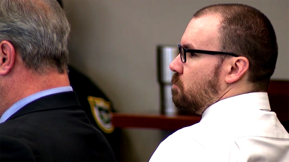 James Melady wearing glasses and a collared shirt as he sits in court
