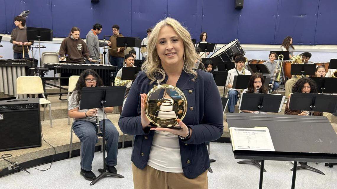 South Miami Senior High School’s Jennifer Jimenez holds her Grammy in her classroom. ‘It’s really tough to fund music education,’ she said.