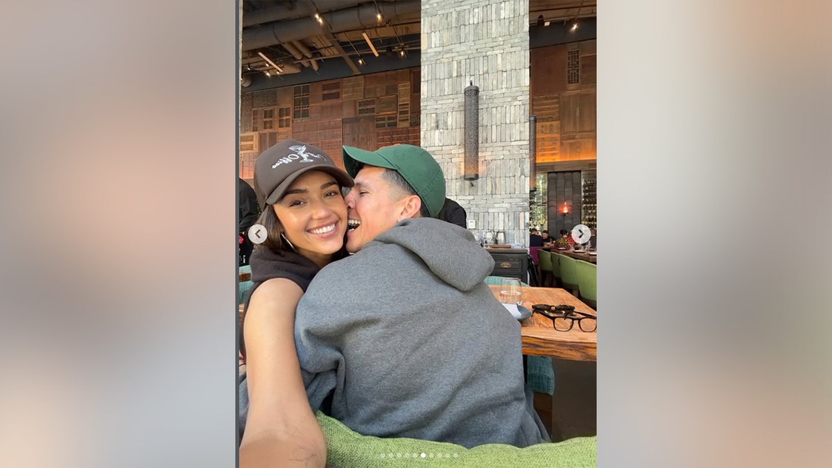 Jessica Alba and Danny Ramirez cuddling while dining out at a restaurant in Miami.