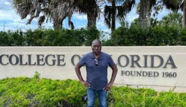 photo of a man standing in front of a sign reading, "College of Florida"