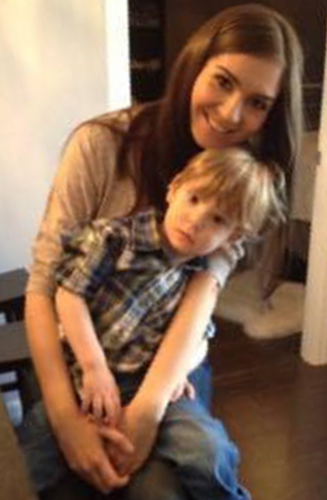 Monika Rubacha smiles while posing with a small blond child, 