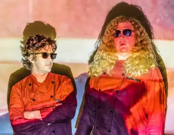 TTN in orange coats and blonde curls