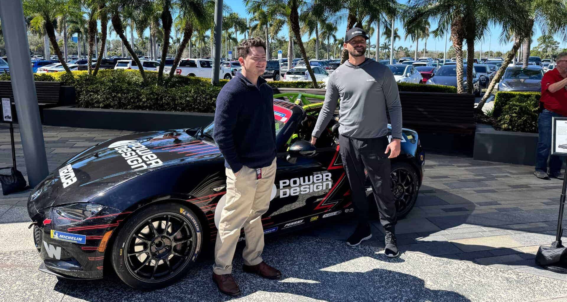 A racecar driver next to his car