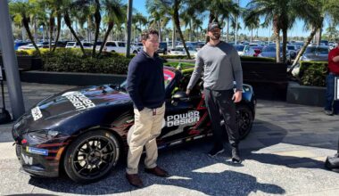 A racecar driver next to his car