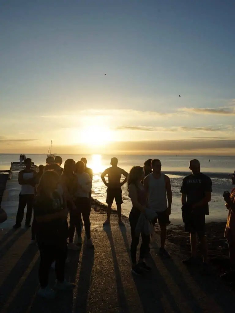 Group silhouette photo in front of a sunset