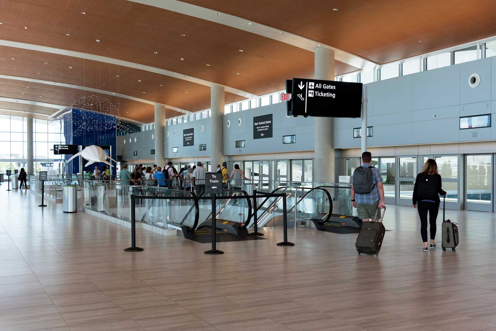 Tampa Airport Terminal in which passengers are walking with their trolley bags