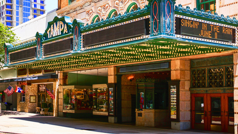 Street view of historic Tampe Theatre, with lit-up green marquee