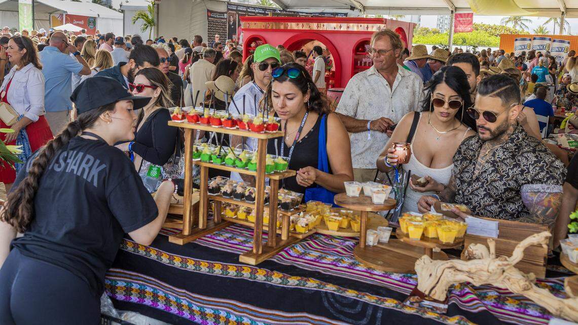 Sonny Mora serves different bites to guests at the Aromas del Peru restaurant booth at the Grand Tasting Village at the 2025 South Beach Wine & Food Festival. Tickets remain to this year’s Grand Tastings.