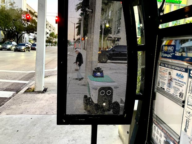 An automated food-delivery robot named "Julio" waits on the corner of Southeast Sixth Street and Andrews Avenue in downtown Fort Lauderdale. (Rod Hagwood / South Florida Sun Sentinel)