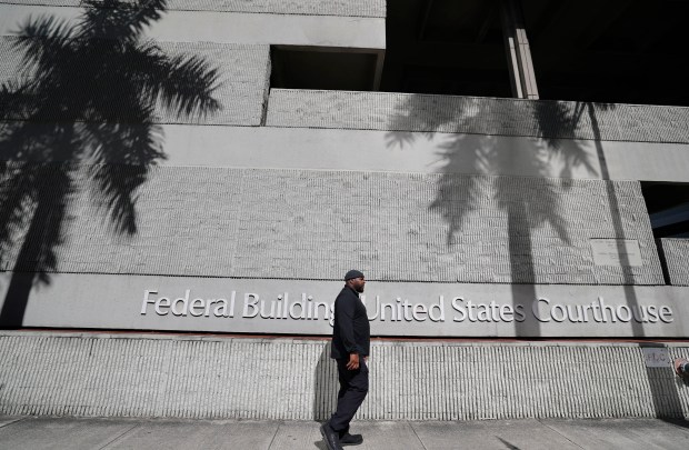 A pedestrian walks past the federal courthouse in Fort Lauderdale on Tuesday. (Amy Beth Bennett/South Florida Sun Sentinel)