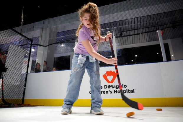 Mia Ekstrom, 11, of Plantation takes a shot at the new "HOCKEY: Faster Than Ever" exhibit at the Museum of Discovery & Science in Fort Lauderdale on Friday, Jan. 30, 2026. (Amy Beth Bennett / South Florida Sun Sentinel)