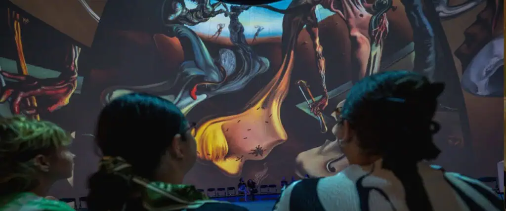 people looking at an art piece