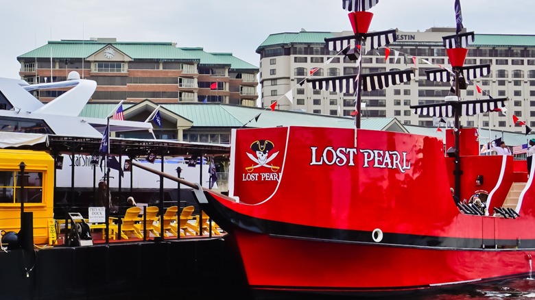 A red pirate ship docks next to a yellow boat on the river in Tampa, Florida.